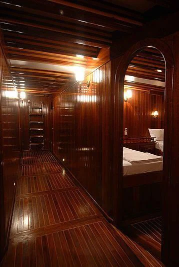 a room with a wood floor and a bed aboard BAHRIYELI C Yacht for Sale
