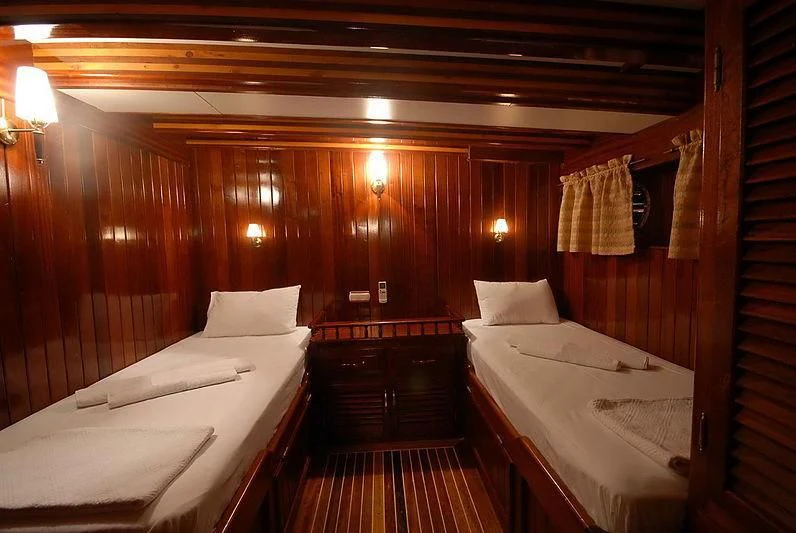 a room with beds and a wood wall aboard BAHRIYELI C Yacht for Sale