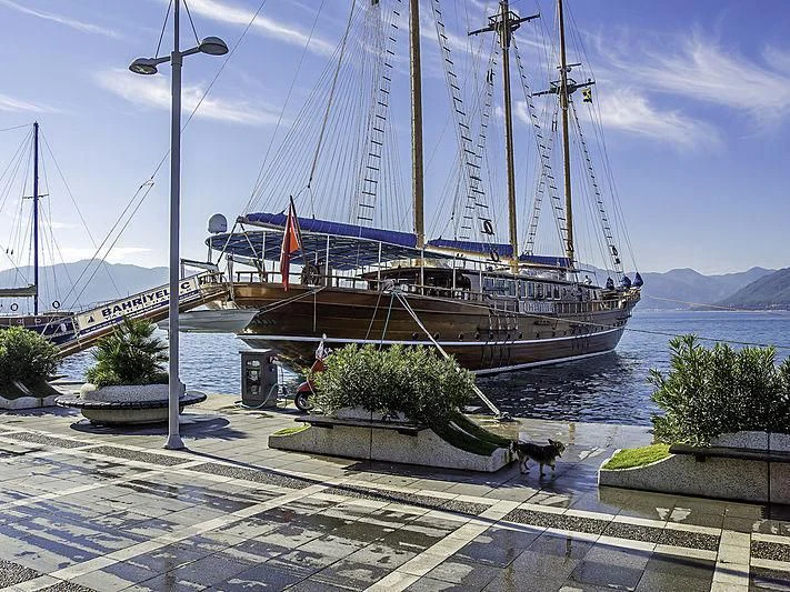 a large ship in a harbor aboard BAHRIYELI C Yacht for Sale
