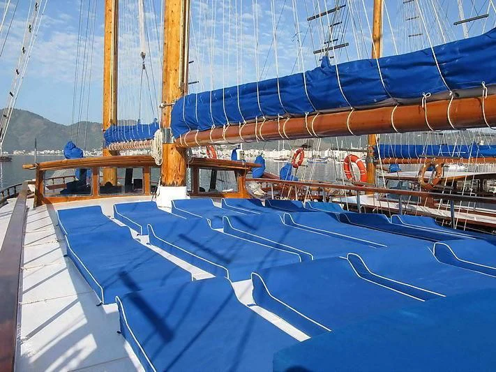 a swimming pool with blue and white striped walls aboard BAHRIYELI C Yacht for Sale