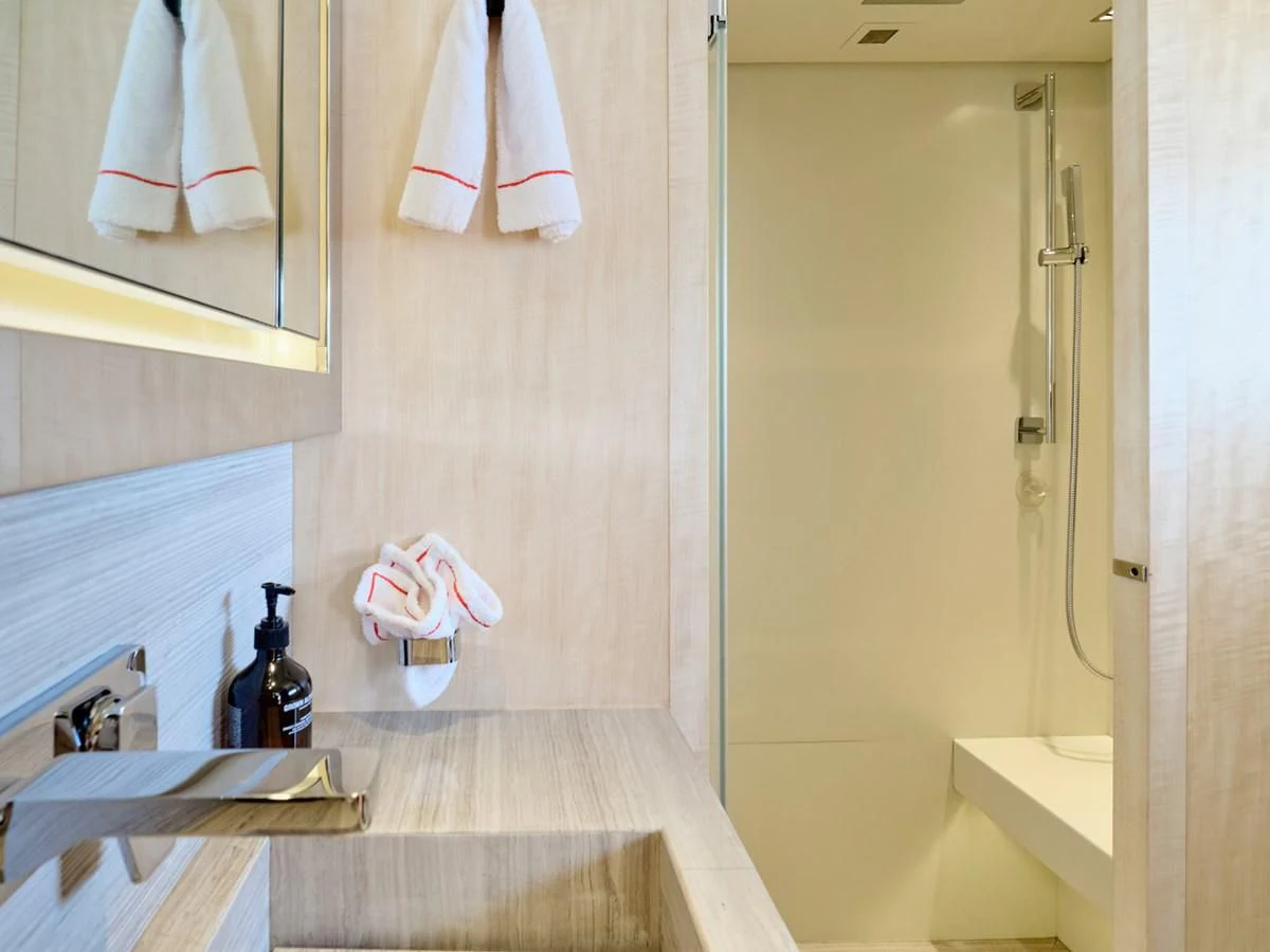 a bathroom with a countertop sink and towels aboard RARE DIAMOND Yacht for Sale