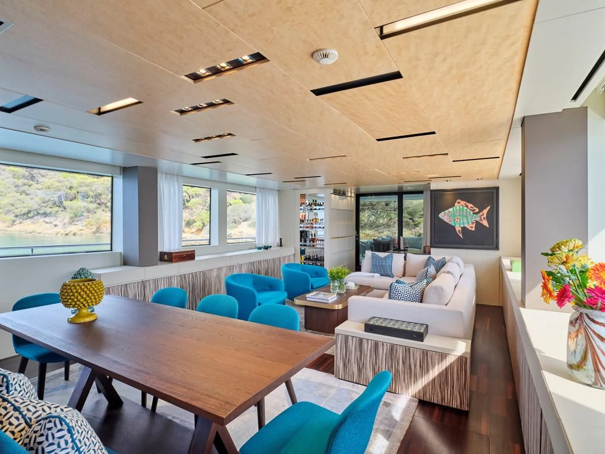 a living room with a table and chairs aboard RARE DIAMOND Yacht for Sale