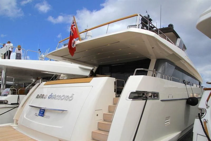 a boat with a flag on the front aboard RARE DIAMOND Yacht for Sale