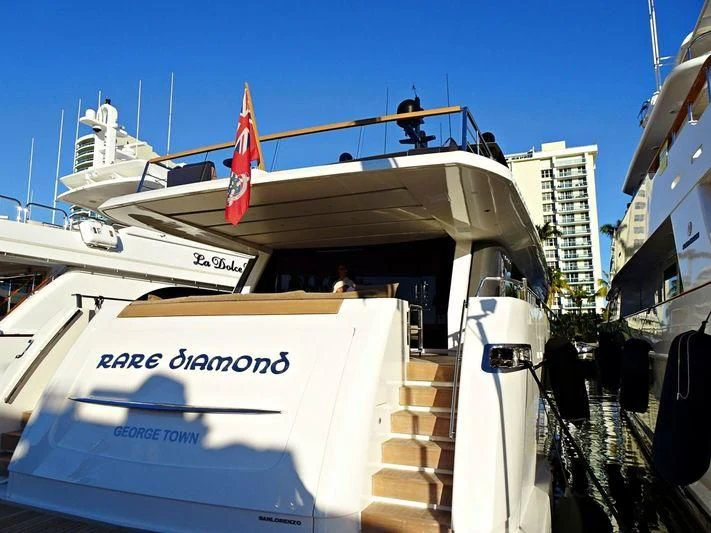 a boat with a flag on the front aboard RARE DIAMOND Yacht for Sale
