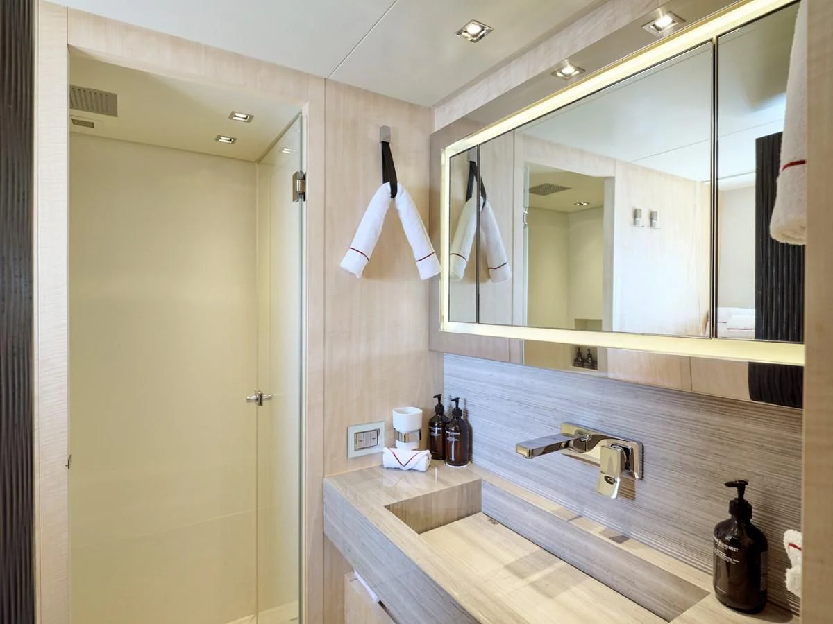 a bathroom with a mirror and countertop sinks aboard RARE DIAMOND Yacht for Sale