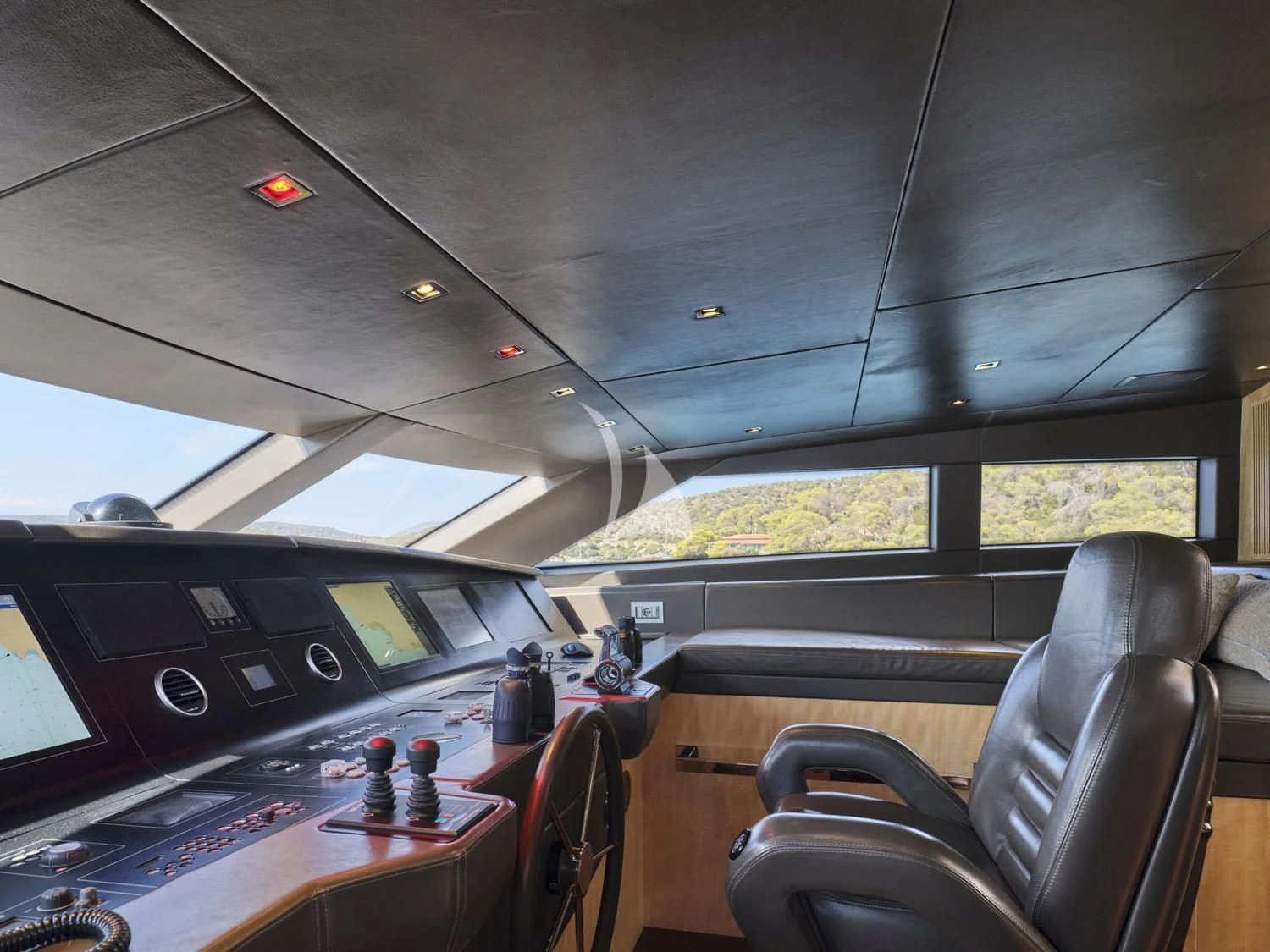 inside of a vehicle with a large screen and a table with chairs and a laptop on it aboard RARE DIAMOND Yacht for Sale