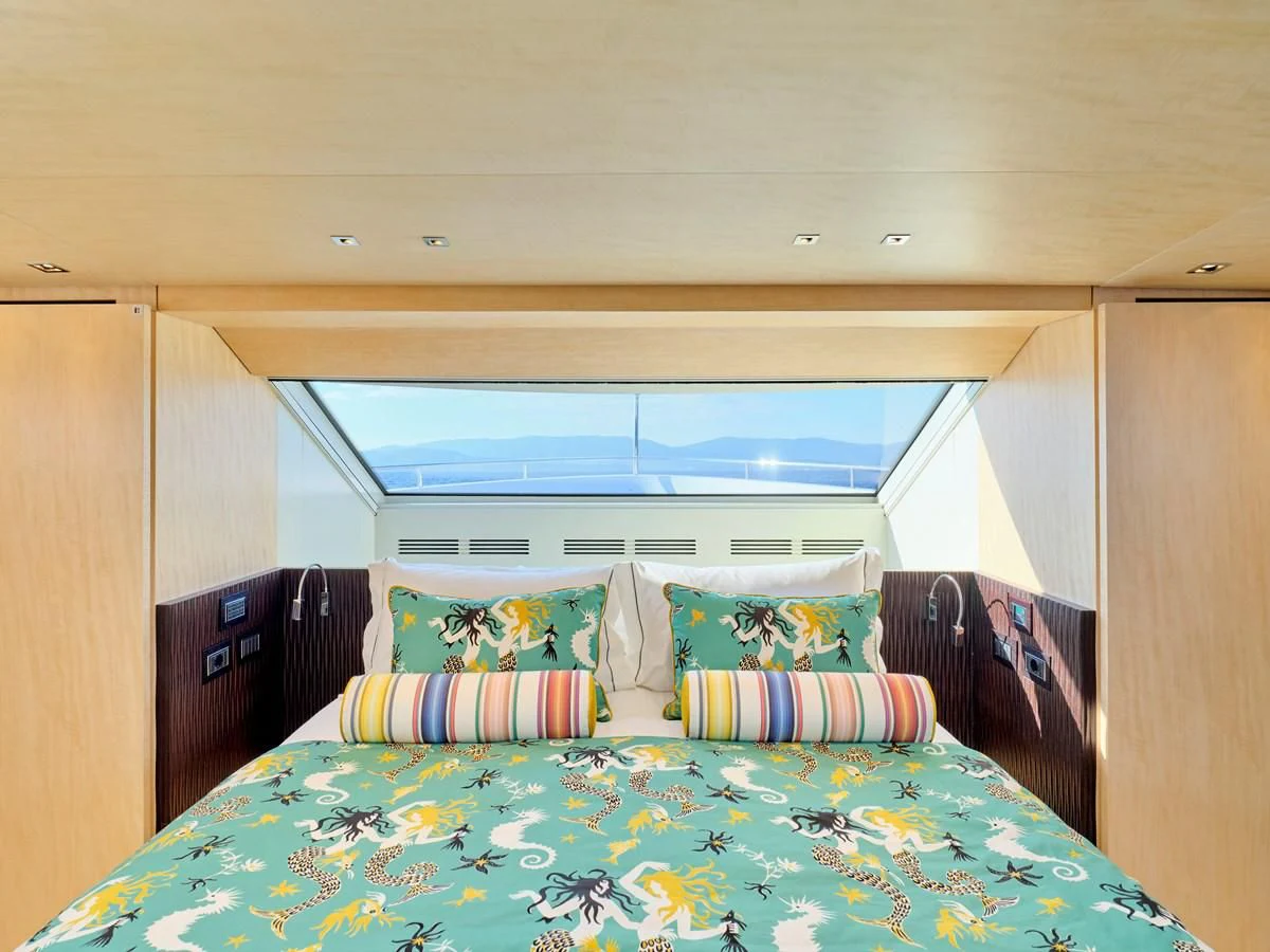 a bed with a large window aboard RARE DIAMOND Yacht for Sale
