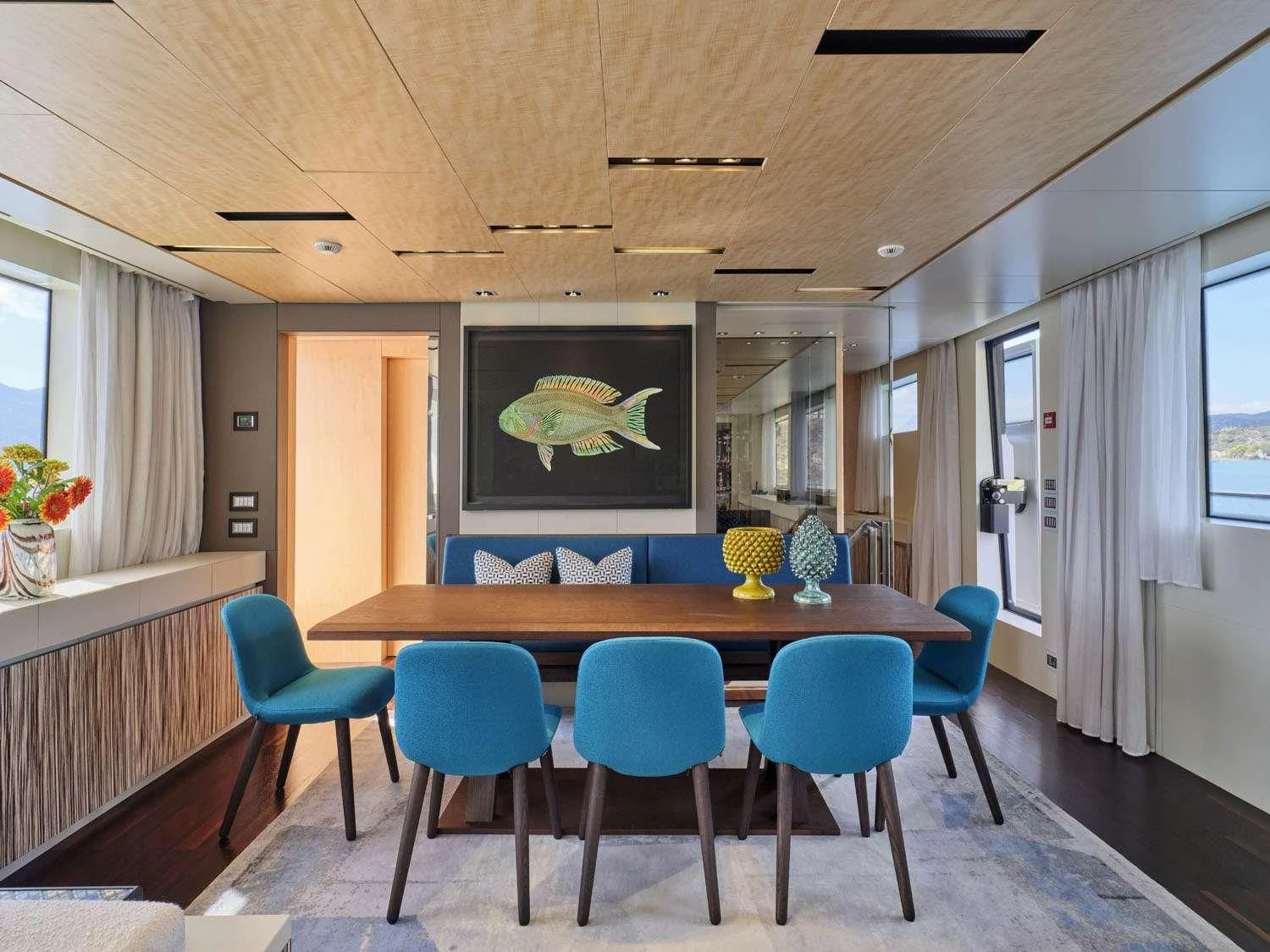 a dining room with blue chairs aboard RARE DIAMOND Yacht for Sale