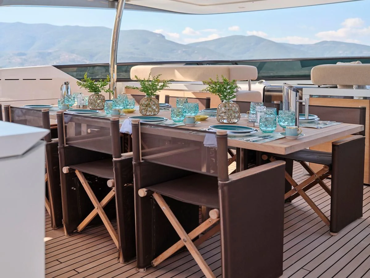 a table with chairs and plants on it aboard RARE DIAMOND Yacht for Sale