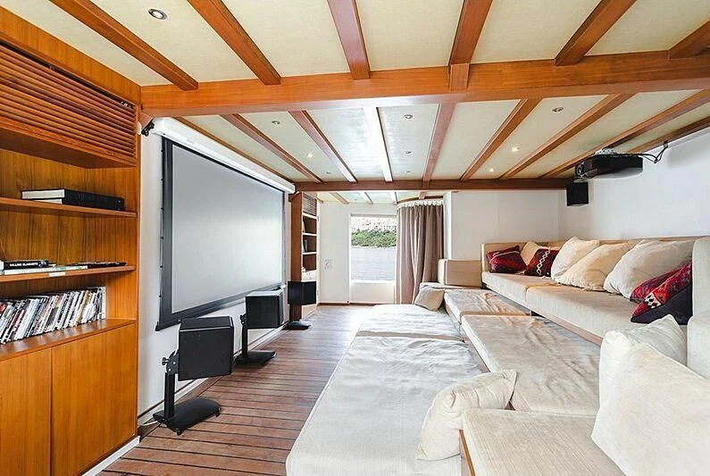 a living room with a large tv aboard DOT Yacht for Sale