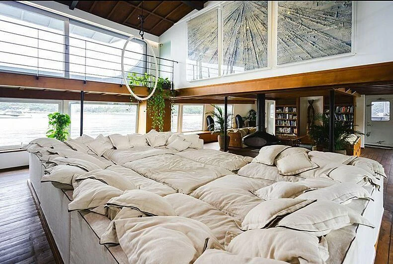 a room with many couches aboard DOT Yacht for Sale