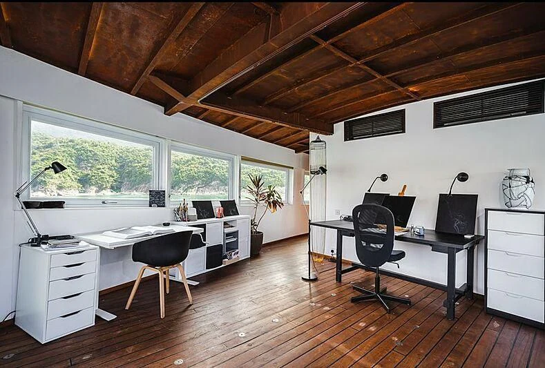 a room with a desk and a computer aboard DOT Yacht for Sale