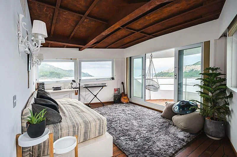 a living room with a large window aboard DOT Yacht for Sale