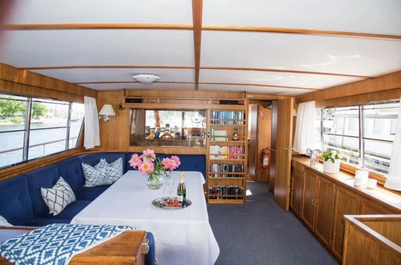 a room with a table and a bed aboard STELLA NOVA Yacht for Sale