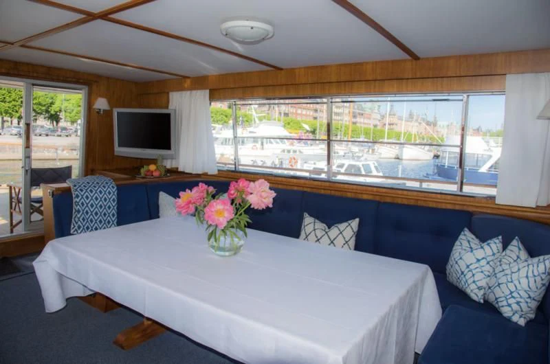 a dining table with flowers on it aboard STELLA NOVA Yacht for Sale