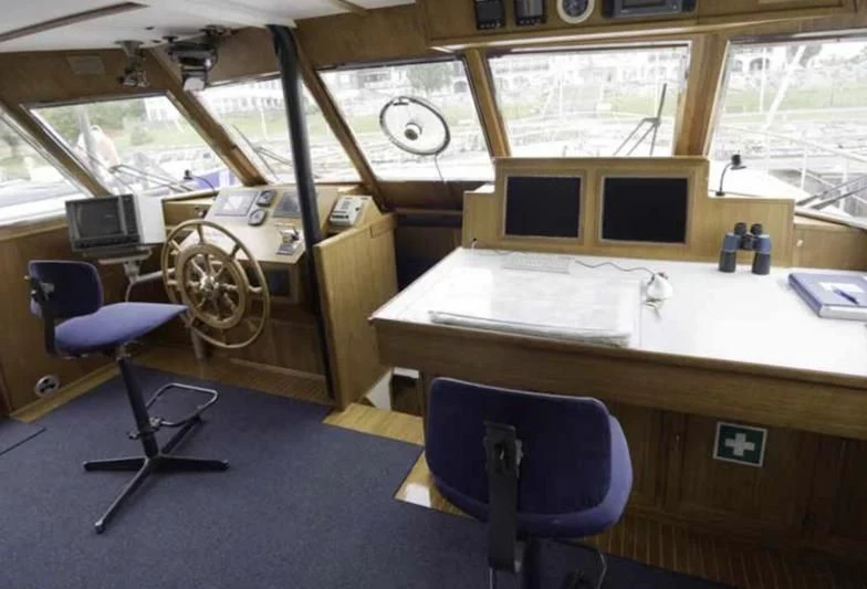 a room with a desk and chairs aboard STELLA NOVA Yacht for Sale