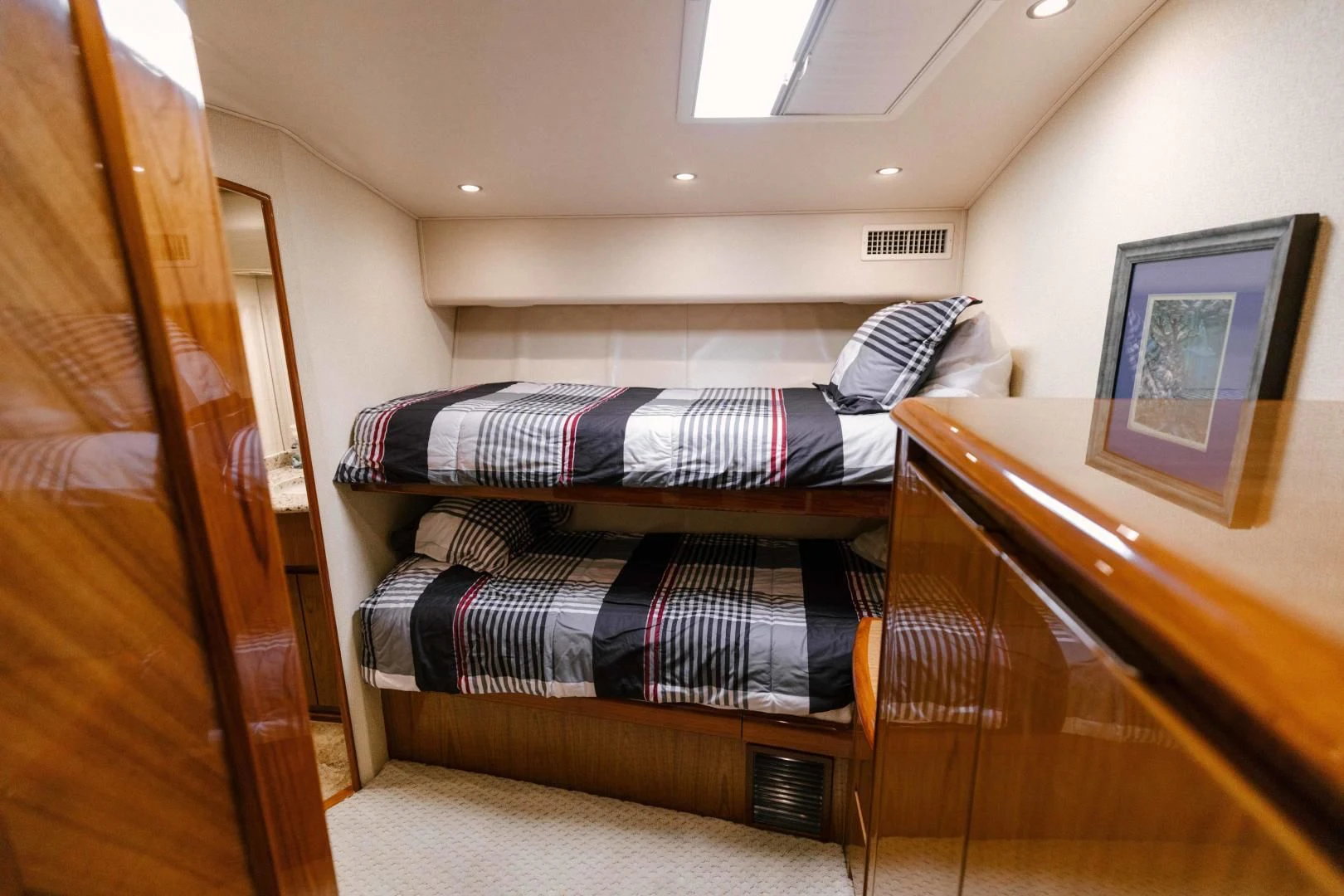 a bunk bed with a striped sheet aboard SALTY K Yacht for Sale