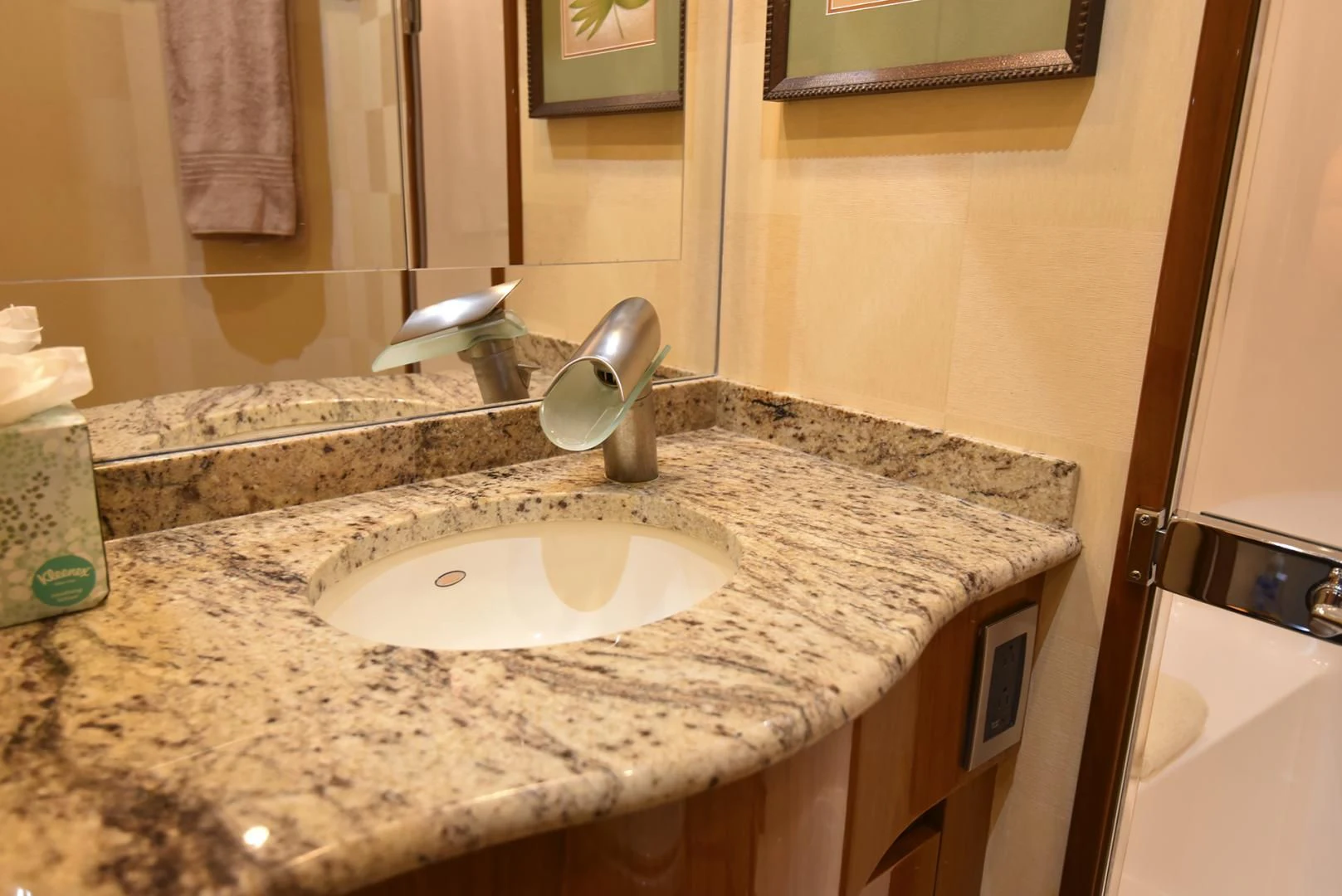 a bathroom with a sink and a mirror aboard SALTY K Yacht for Sale