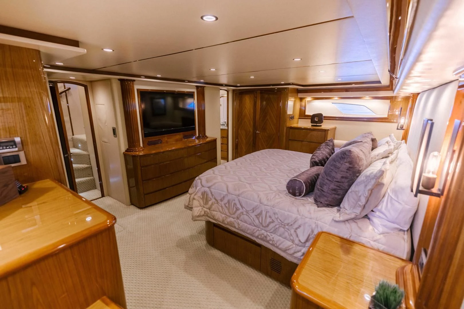 a bedroom with a bed and a television aboard SALTY K Yacht for Sale