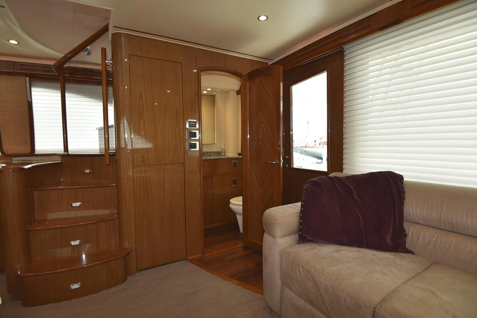 a living room with a couch and a wood door aboard SALTY K Yacht for Sale