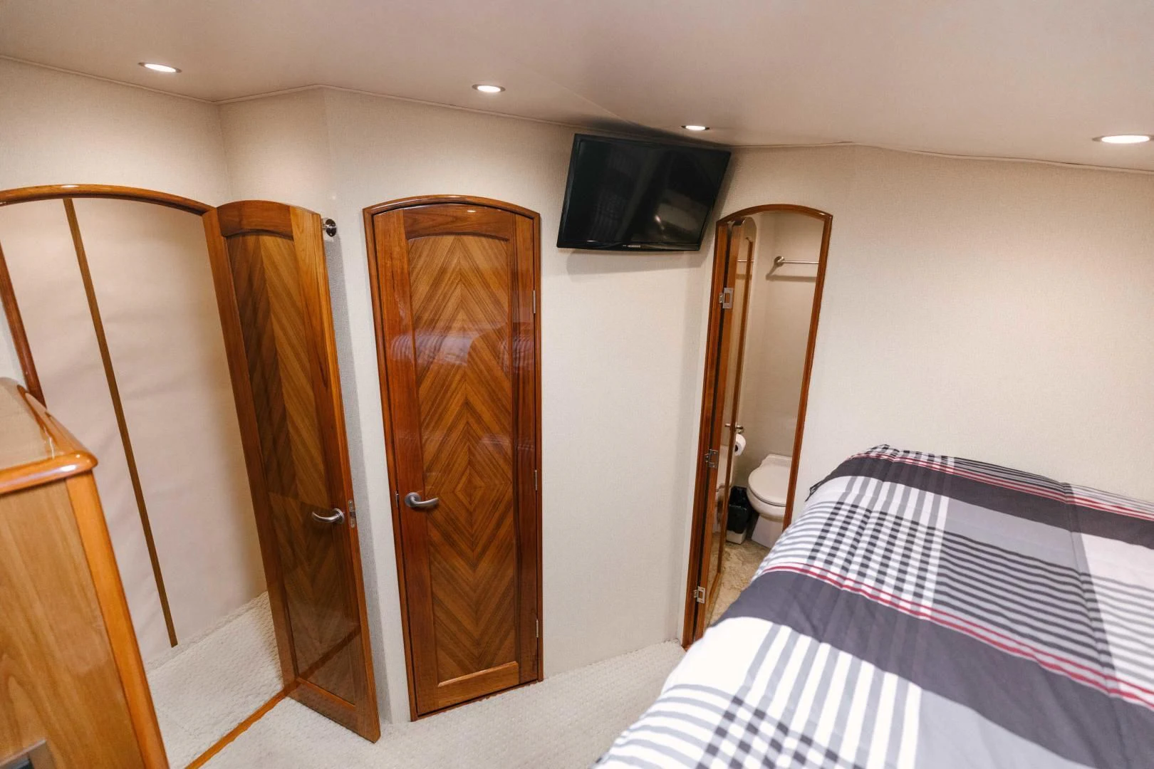 a bedroom with a bed and a television aboard SALTY K Yacht for Sale