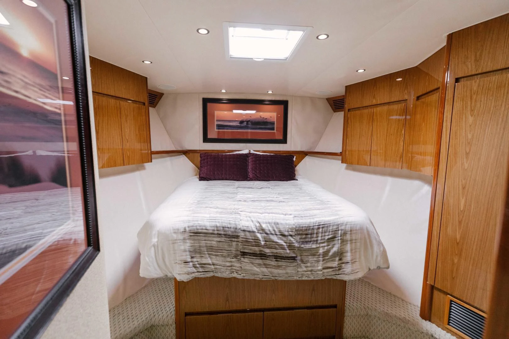a bedroom with a bed and a mirror aboard SALTY K Yacht for Sale