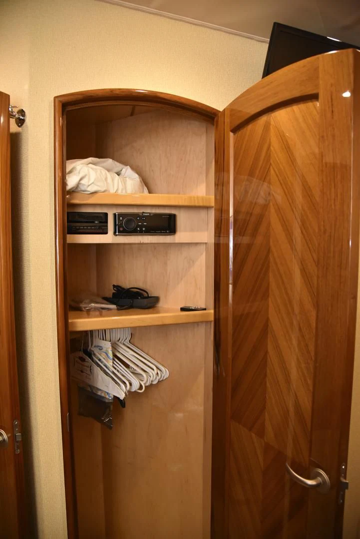 a closet with clothes and a phone aboard SALTY K Yacht for Sale