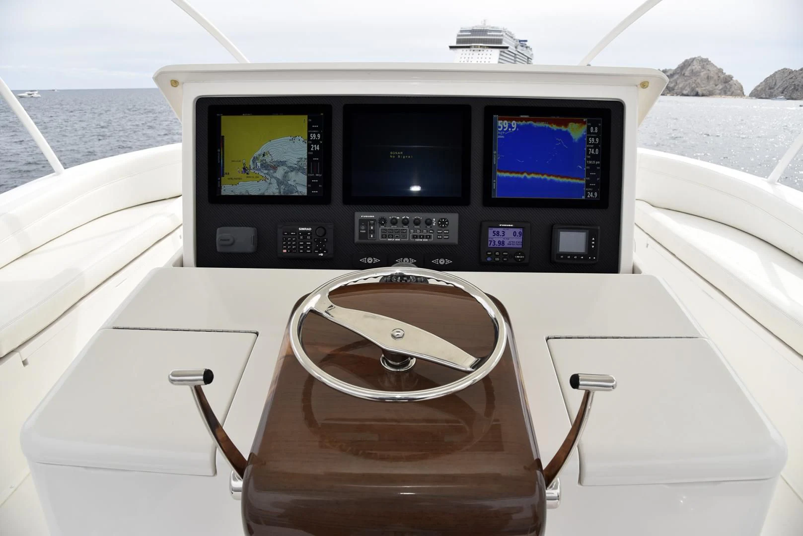 a boat with a screen and steering wheel on the front aboard SALTY K Yacht for Sale