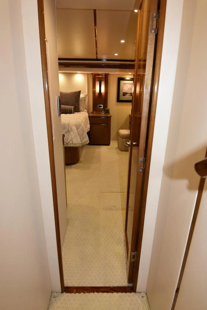 a hallway with a bed and a mirror aboard SALTY K Yacht for Sale