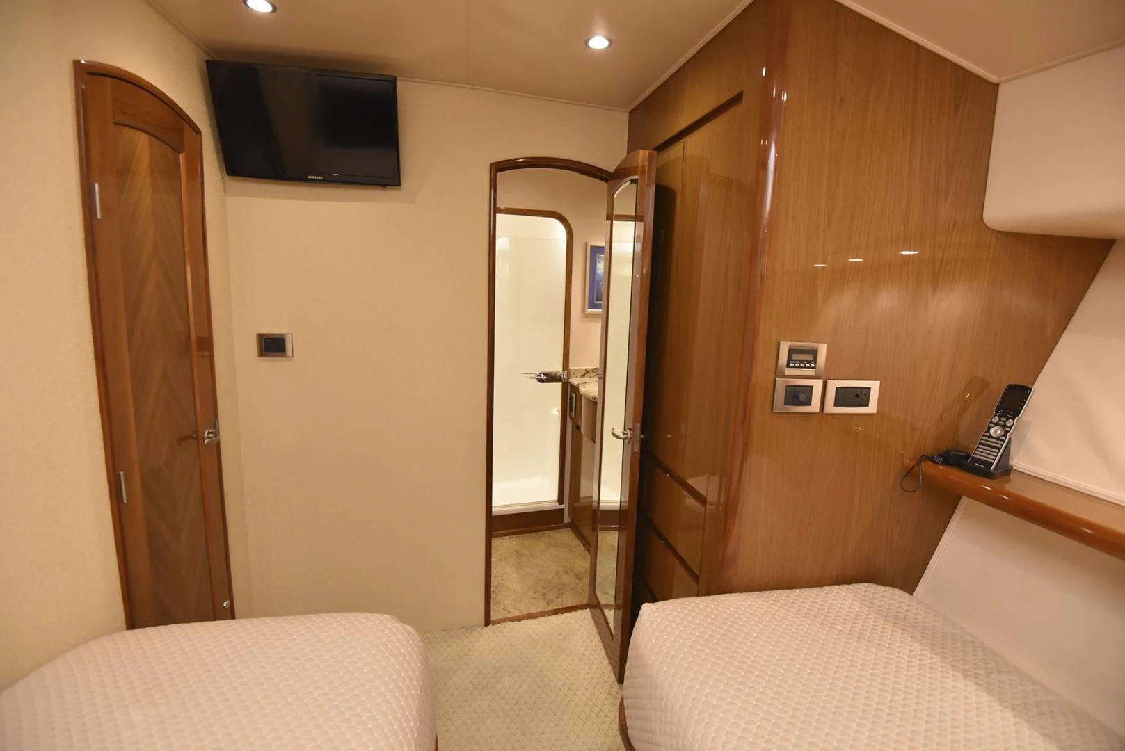 a hotel room with a bed and tv aboard SALTY K Yacht for Sale