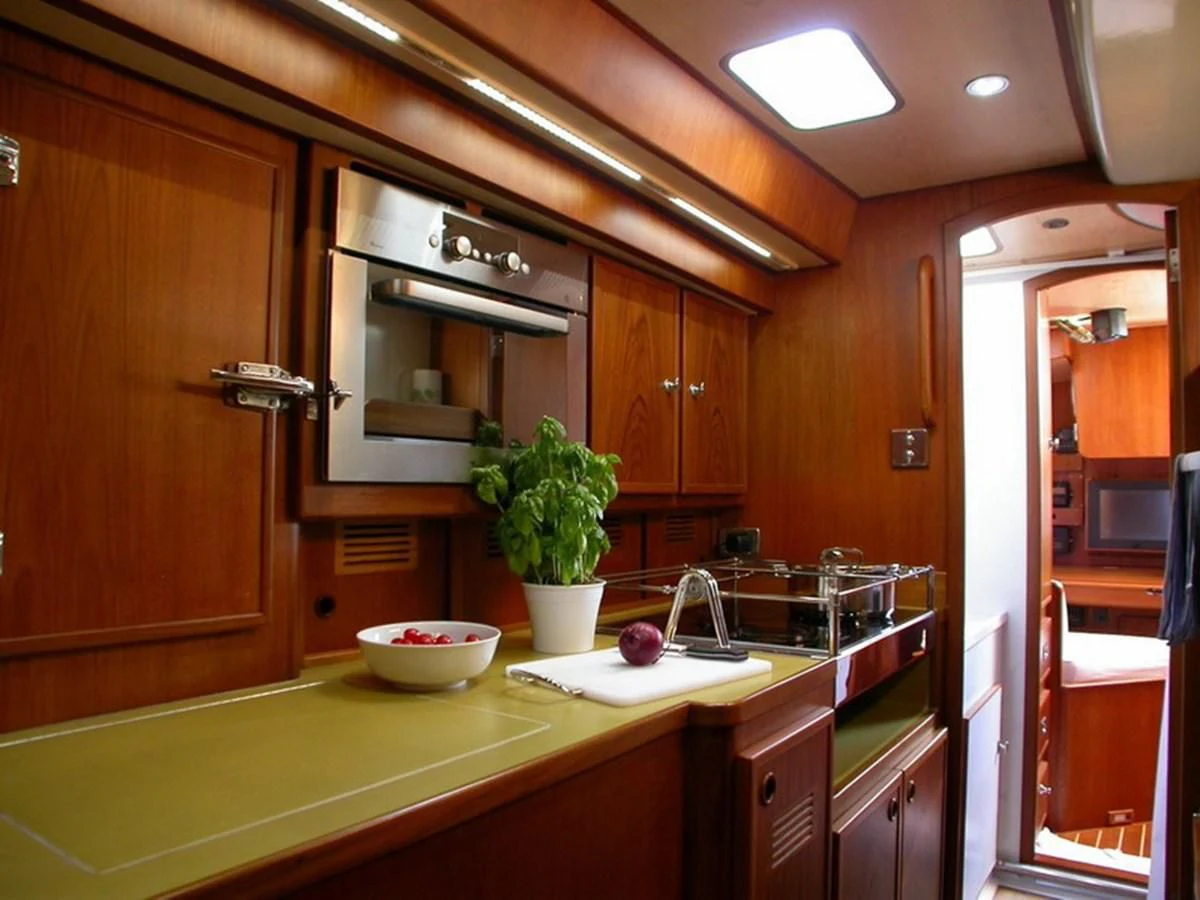 a kitchen with wooden cabinets aboard MATCHLESS Yacht for Sale