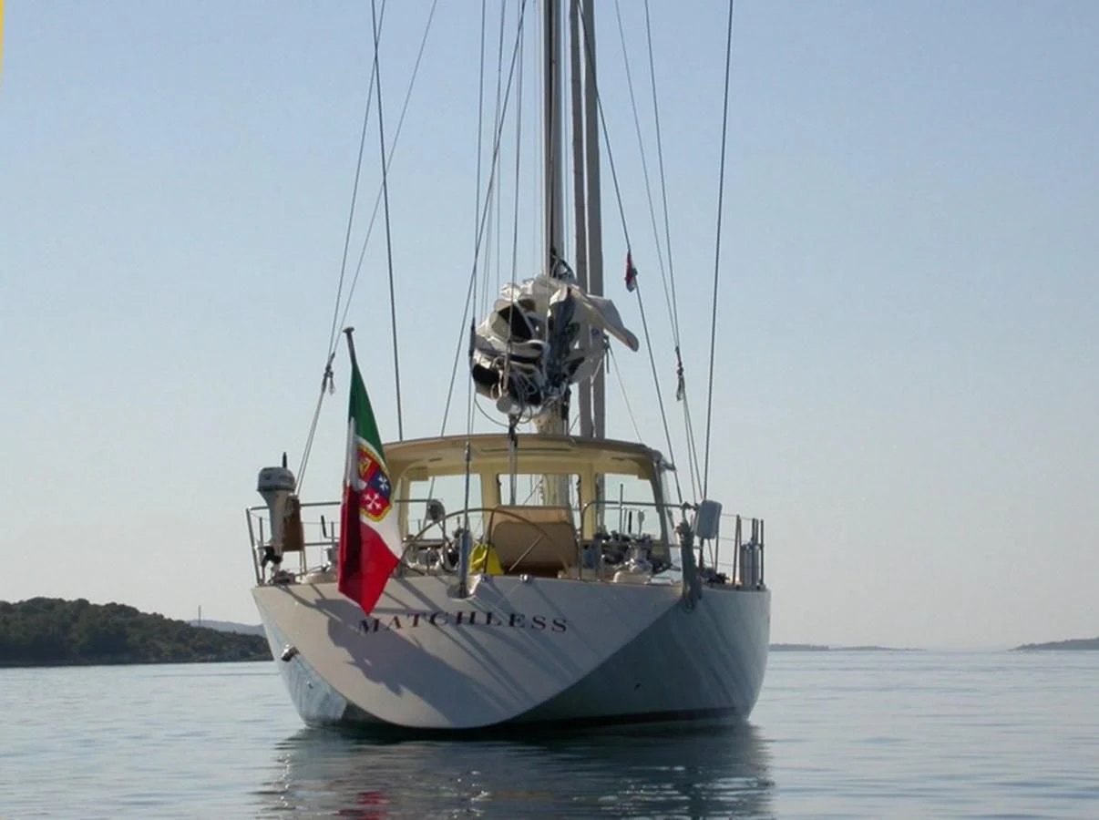 a boat with a flag on it aboard MATCHLESS Yacht for Sale