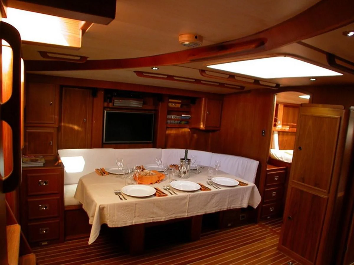 a kitchen with a table and chairs aboard MATCHLESS Yacht for Sale