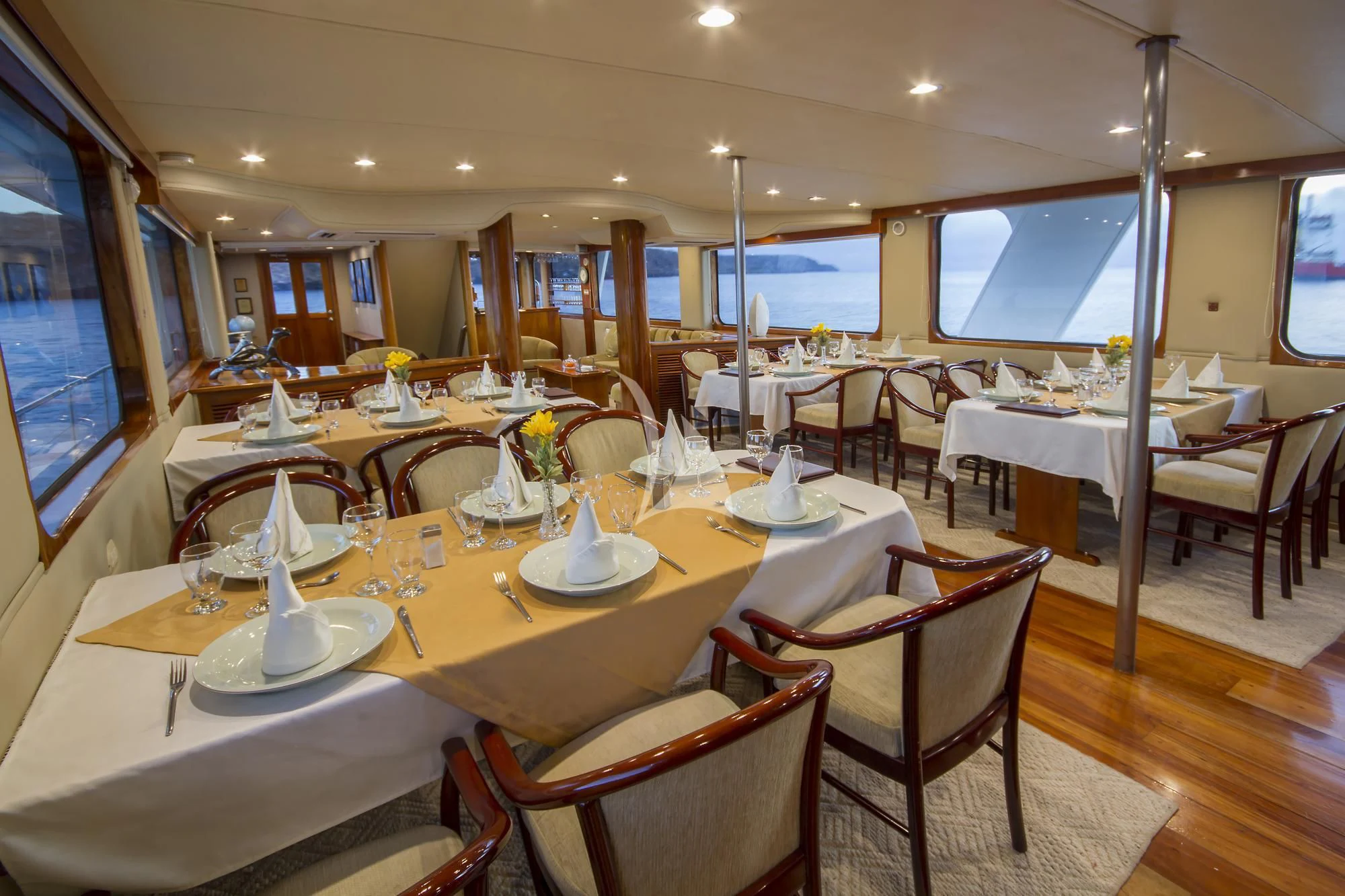 a restaurant with tables and chairs aboard INTEGRITY Yacht for Sale