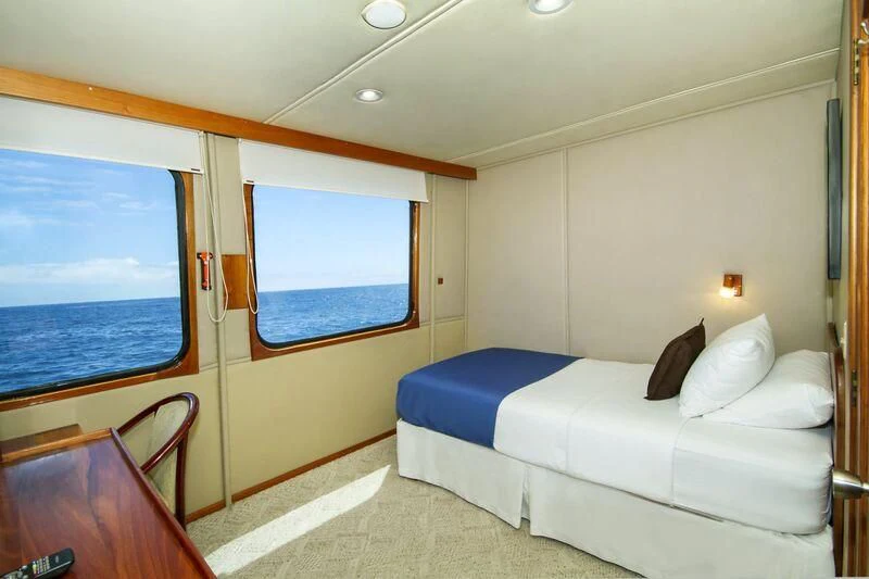 a room with a bed and a window aboard INTEGRITY Yacht for Sale