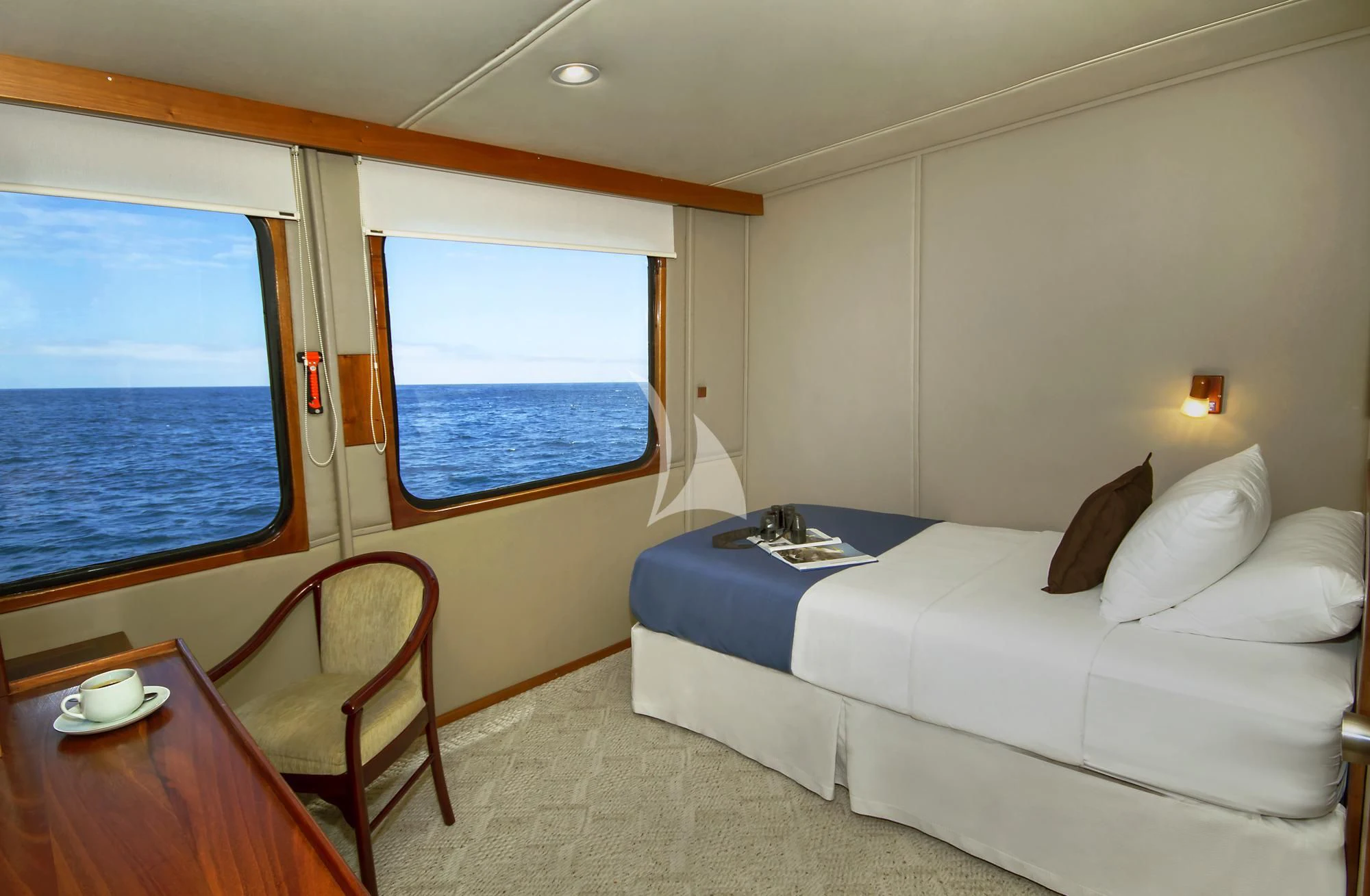 a room with a bed and a table aboard INTEGRITY Yacht for Sale