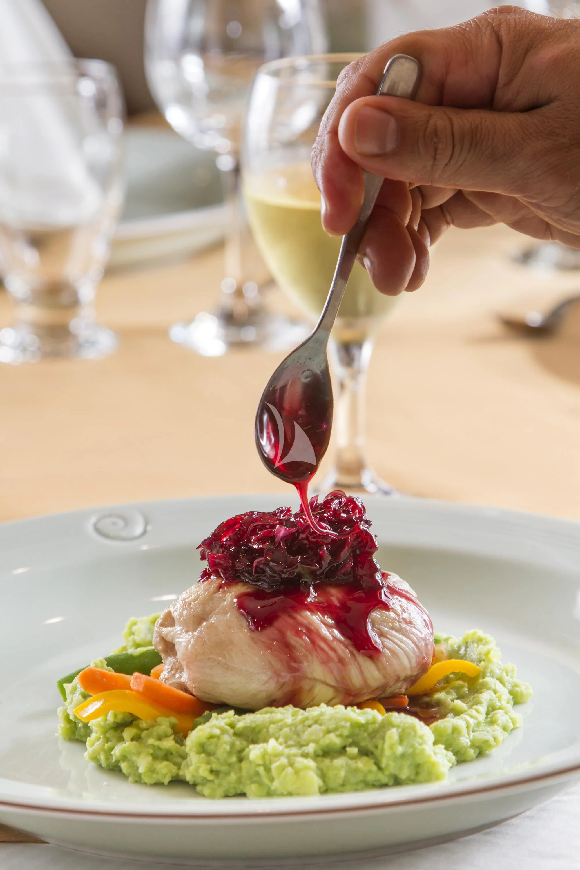 a hand pouring a liquid into a bowl of food aboard INTEGRITY Yacht for Sale