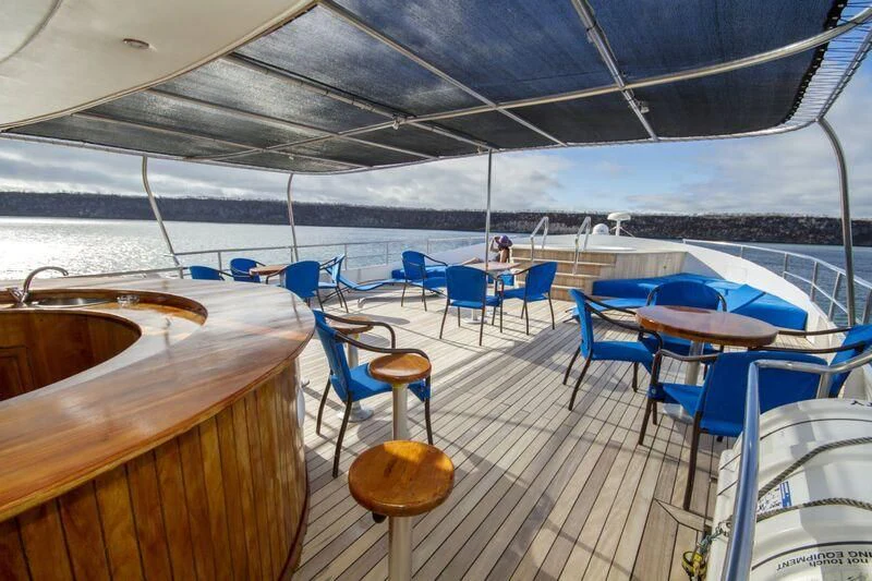 a boat deck with blue chairs aboard INTEGRITY Yacht for Sale