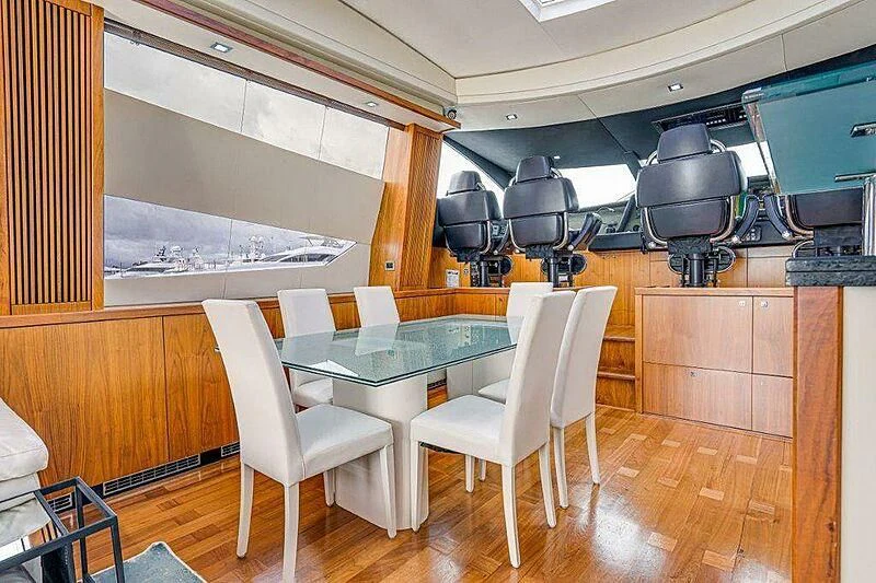 a room with a table and chairs aboard SKY FALL Yacht for Sale