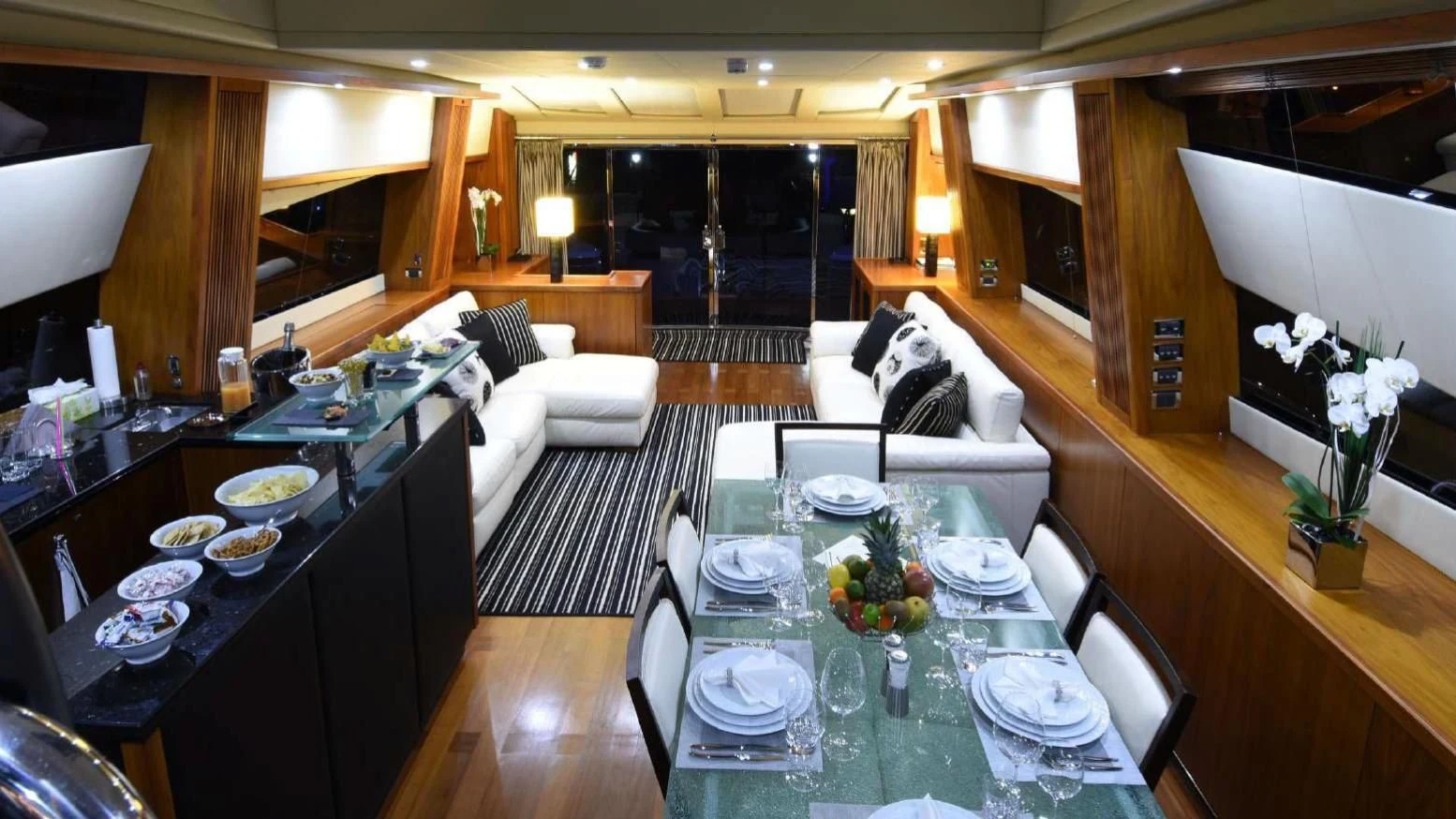 a dining room with a table and chairs aboard SKY FALL Yacht for Sale