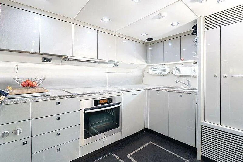 a kitchen with white cabinets aboard SKY FALL Yacht for Sale