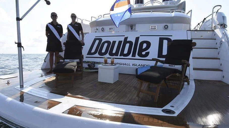 a group of people standing on a boat aboard SKY FALL Yacht for Sale