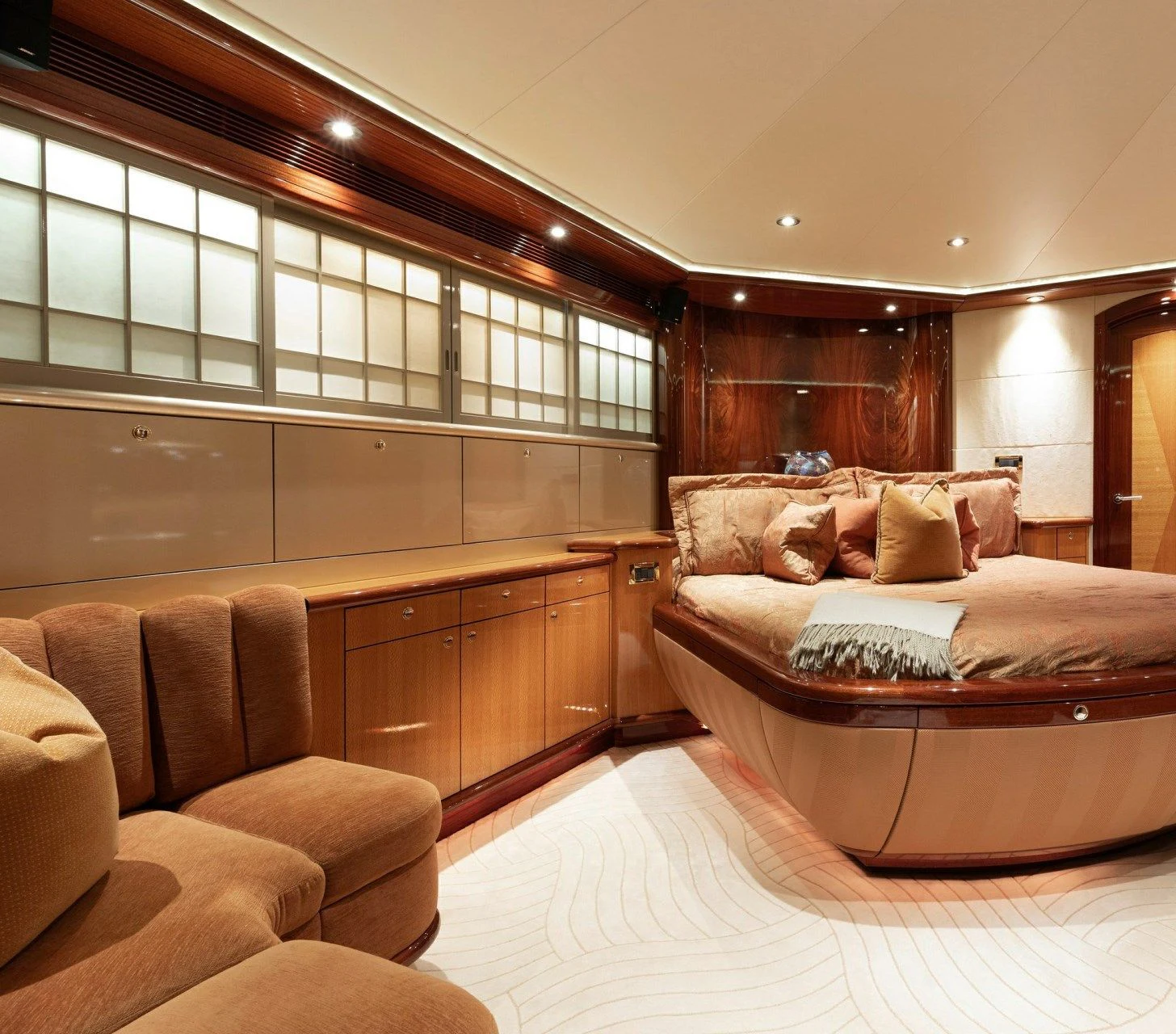 a bedroom with a bed and a couch aboard DRIVEN Yacht for Sale
