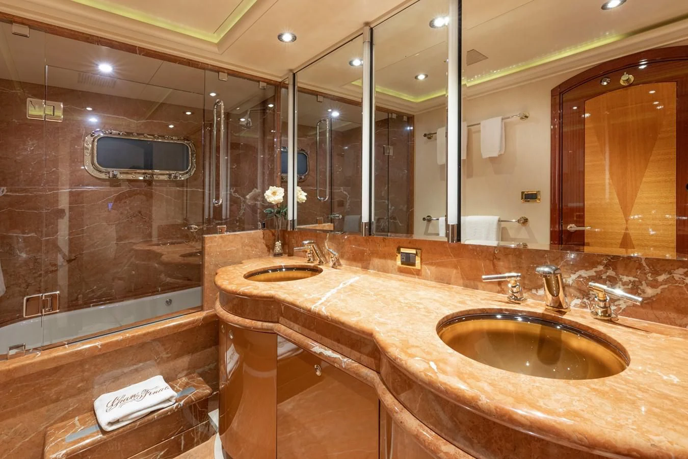 a bathroom with a large mirror aboard DRIVEN Yacht for Sale