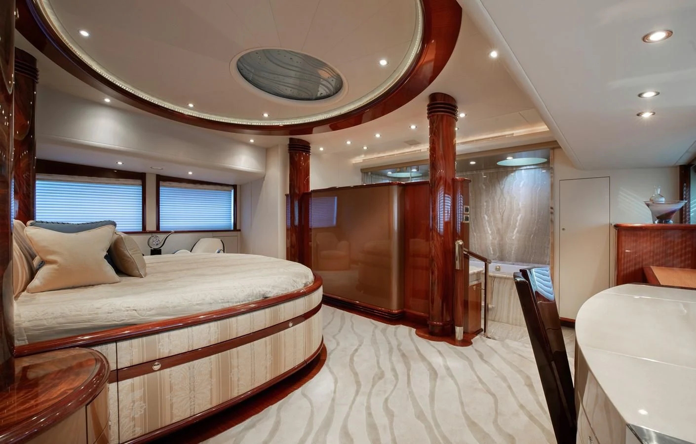 a room with a bed and a table aboard DRIVEN Yacht for Sale