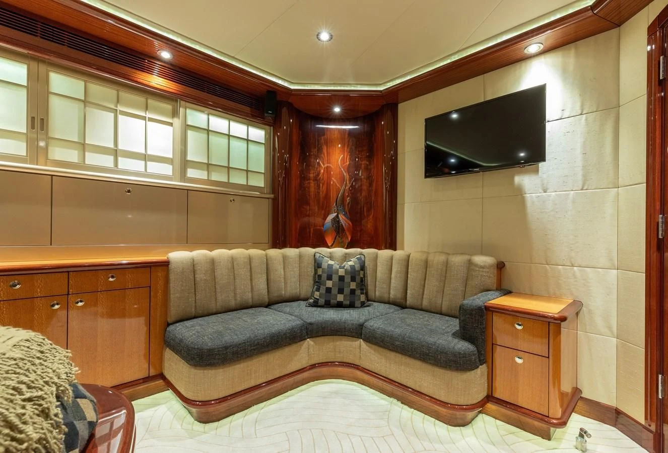 a living room with a couch and a tv aboard DRIVEN Yacht for Sale