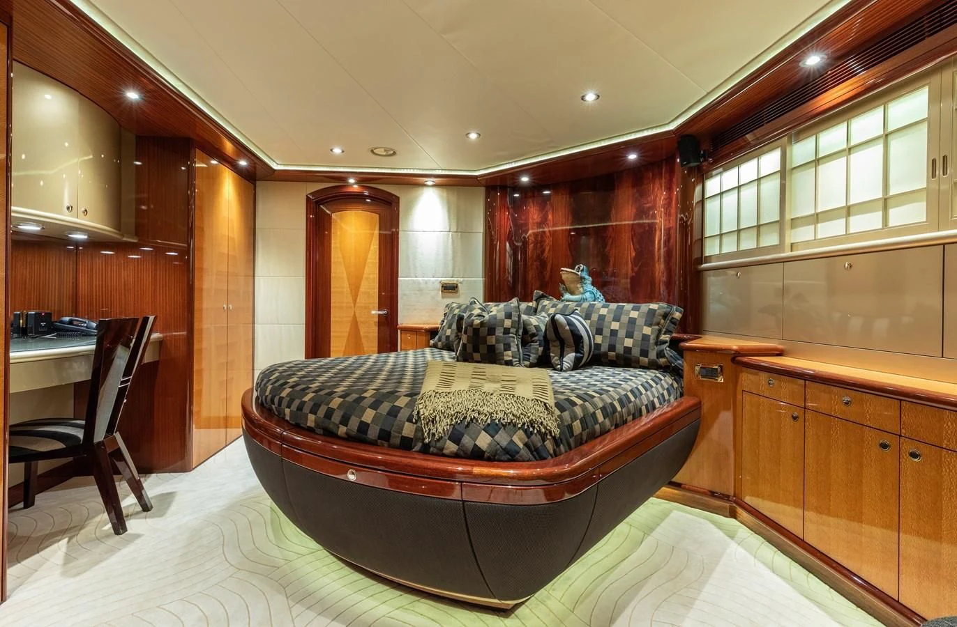 a bedroom with a bed and desk aboard DRIVEN Yacht for Sale