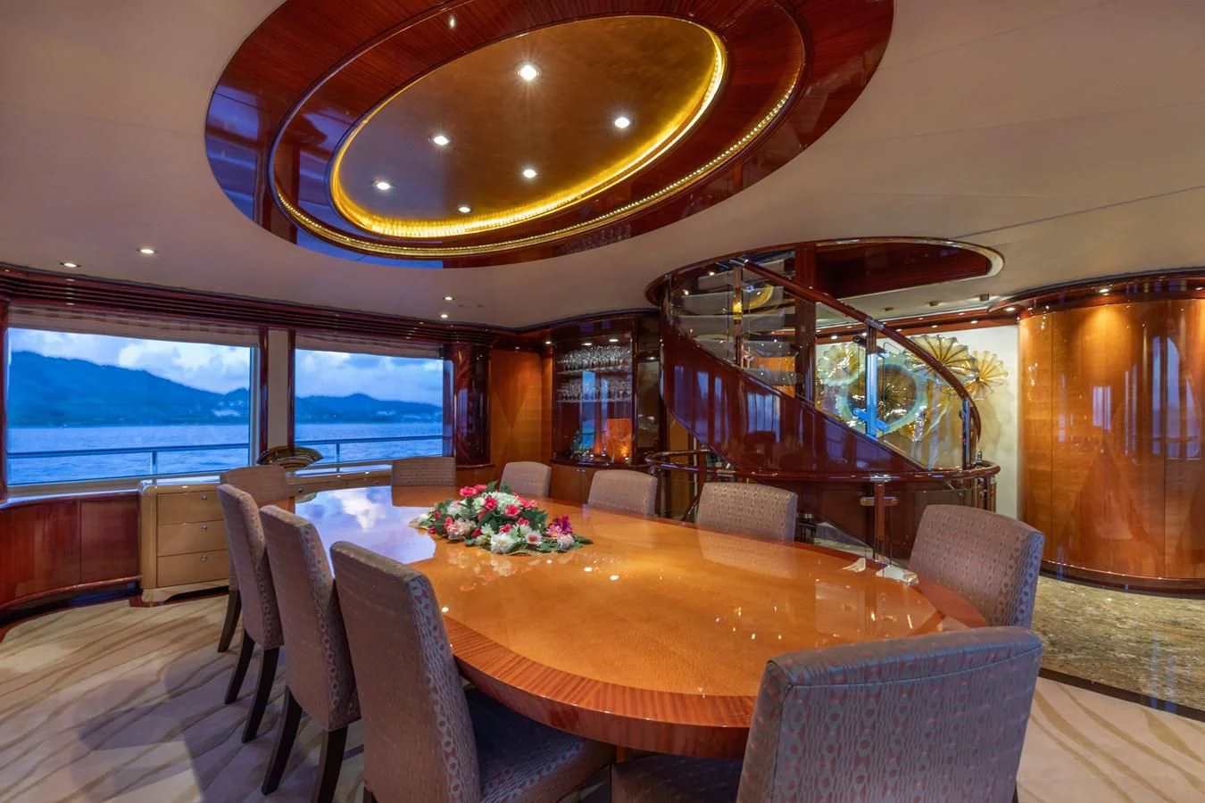 a dining room with a large window aboard DRIVEN Yacht for Sale