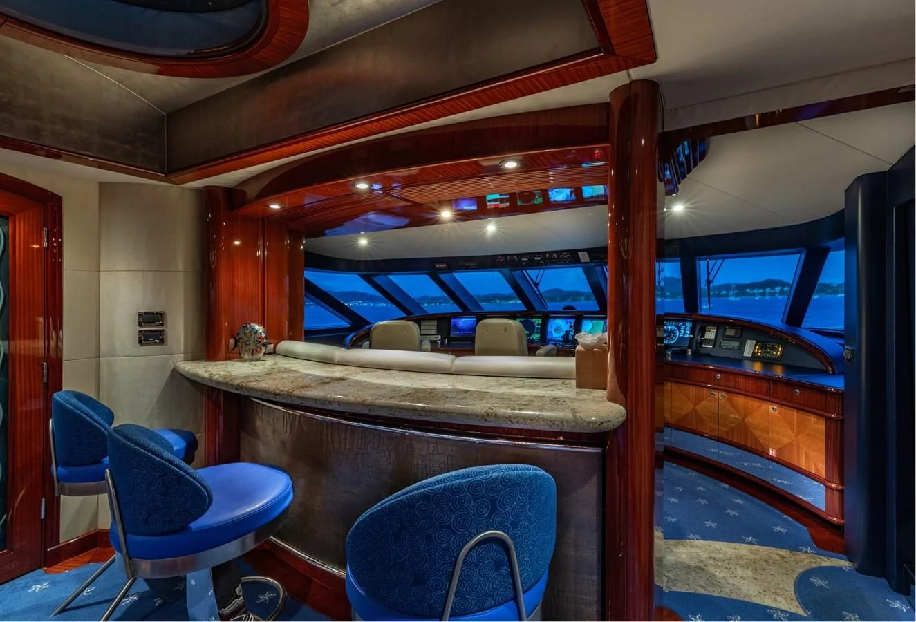 a room with a table and chairs aboard DRIVEN Yacht for Sale