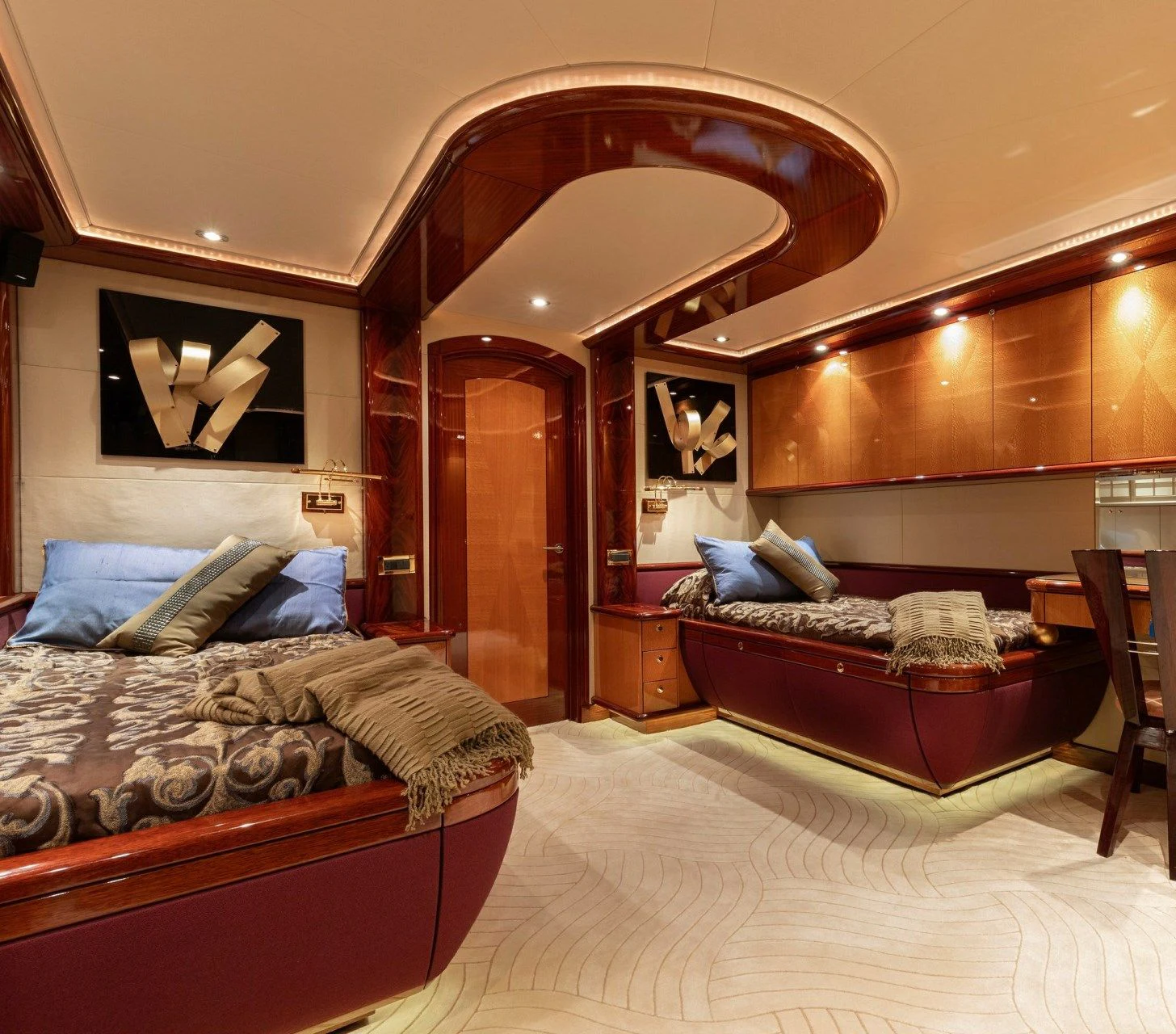 a bedroom with a bed and a large mirror aboard DRIVEN Yacht for Sale